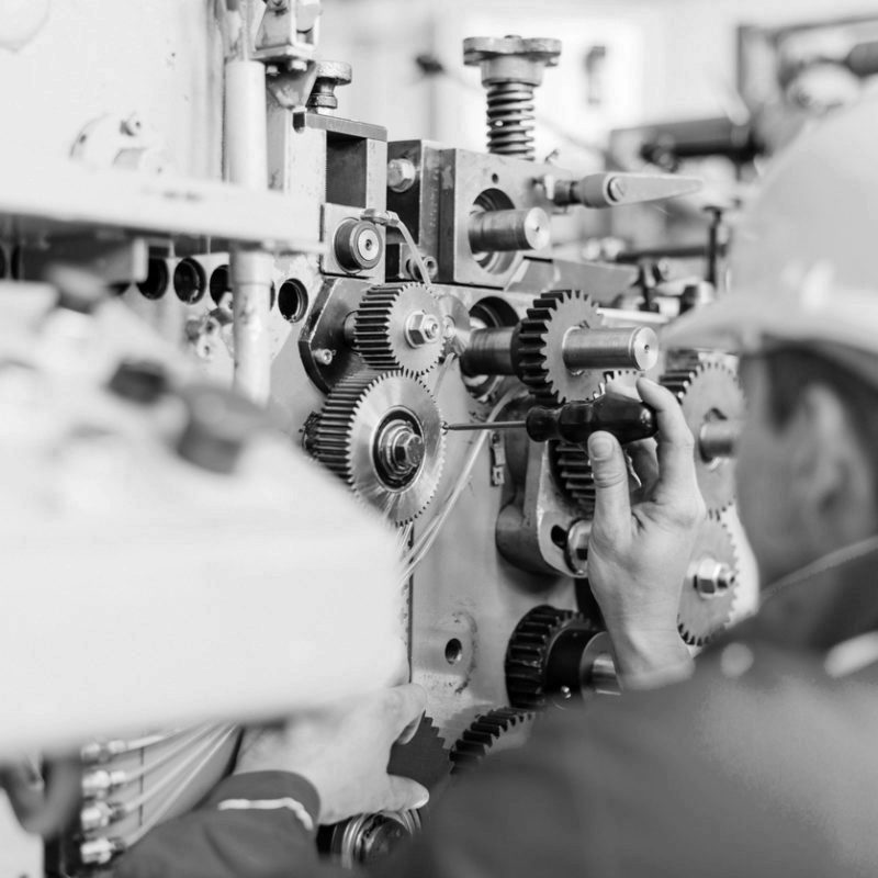 Maintenance engineer in factory installing the engine